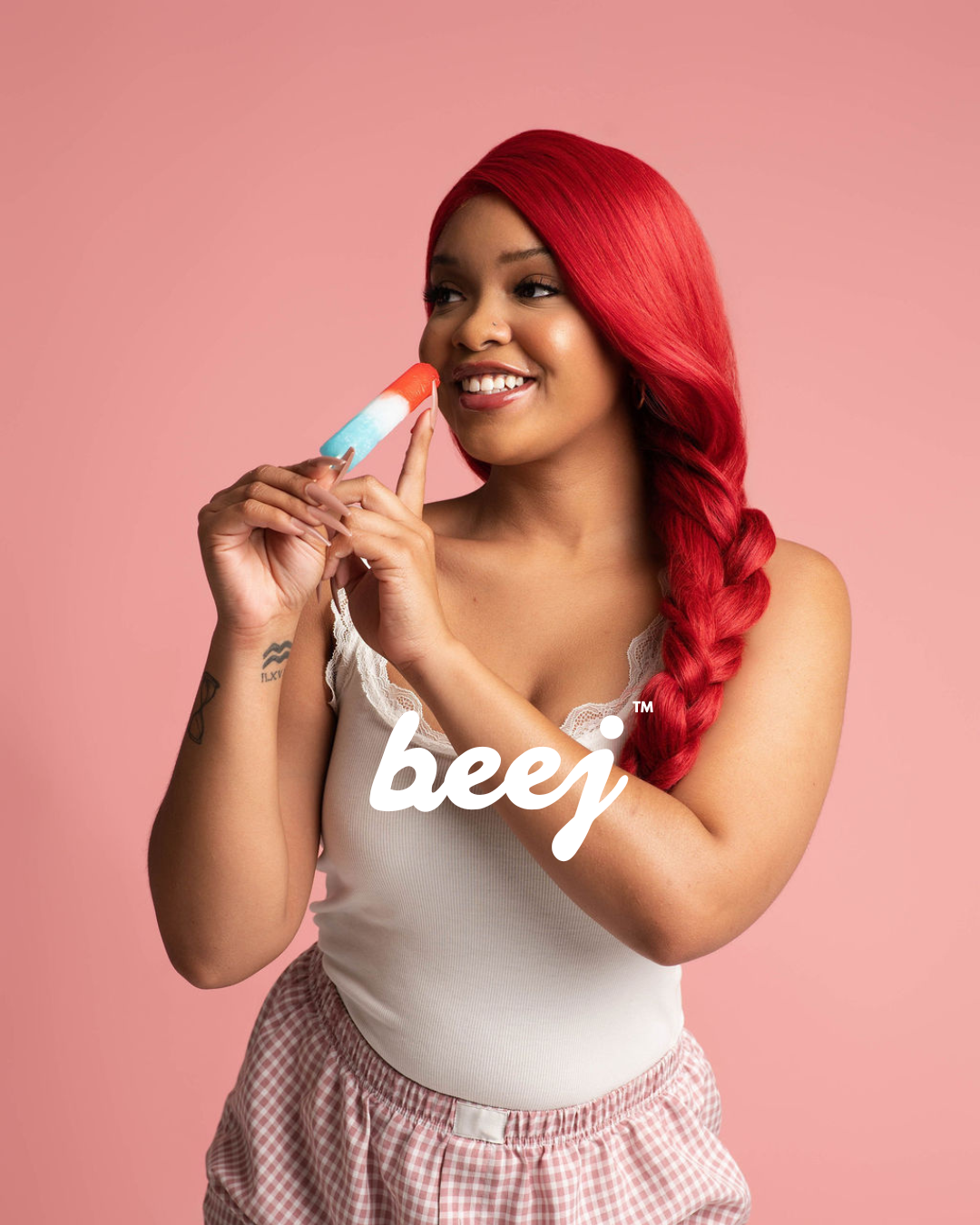 Woman with red hair holding a product against a pink background, with 'beej' branding.