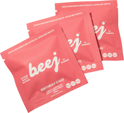 pink packets of 'beej' Birthday Cake flavor bj gummies on a white background