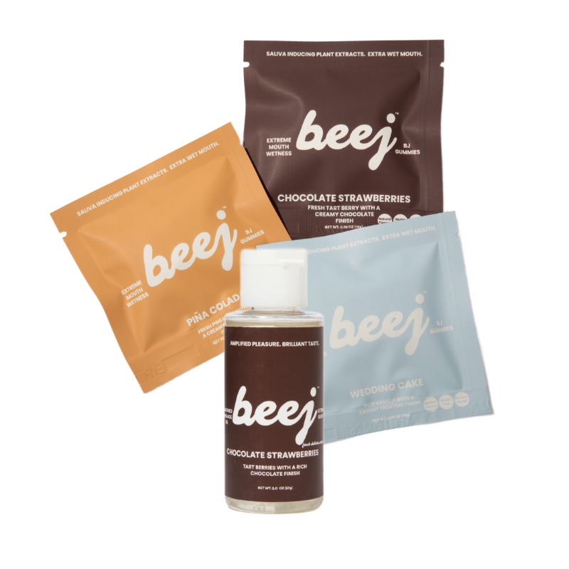 beej oral sex candy and edible massage oil product packaging including a bottle and three packets on a white background