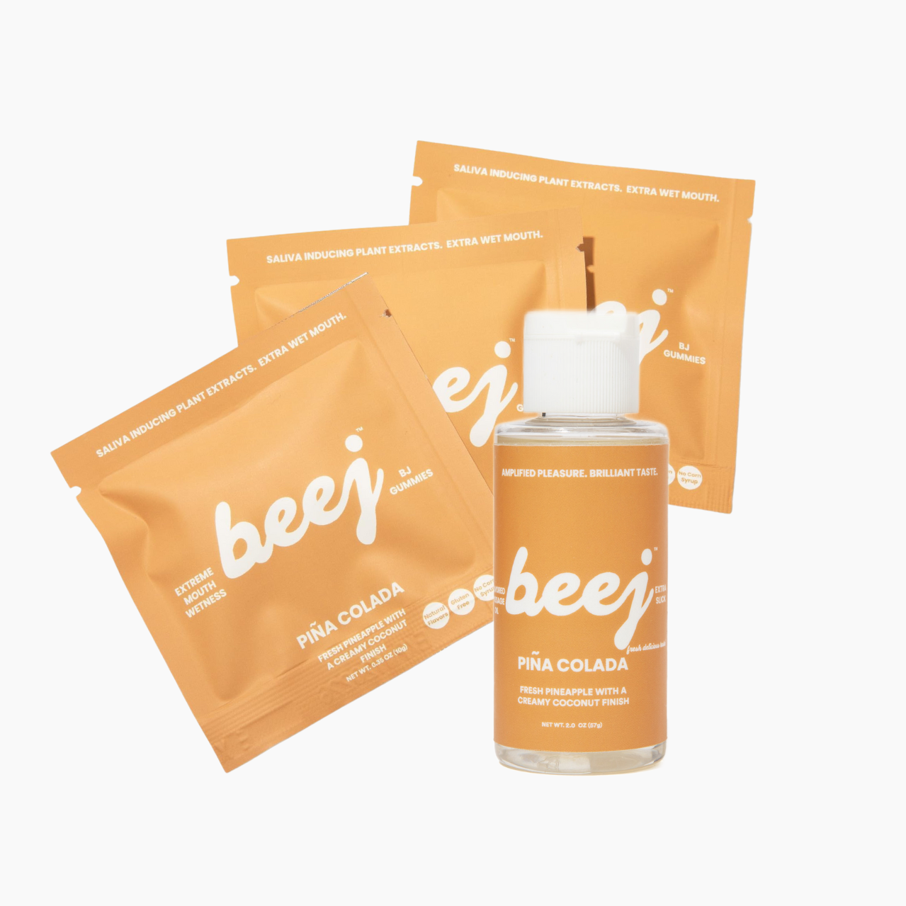 The image displays a "Piña Colada Extra Slick Bundle" from the brand beej. It includes a clear bottle of flavored oil and several orange sachets of gummies, all arranged neatly on a white background.
